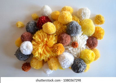 A Large Pile Of Yellow And Gold Handmade Yarn Pom Poms, Texture And Bright Colors, Flat Lay/from Above Style