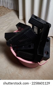A large pink basin with old stationery for throwing away. Environmental pollution. Unnecessary things. Once necessary, but now unnecessary folders and trays in the room - Shutterstock ID 2258601129