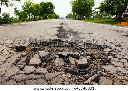 Large pit on asphalting highway.