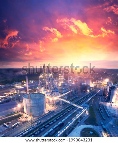large plant, aerial photo drone. Large metal structures, pipes, a railway line with hundreds of wagons, bright lighting, energy and power metallurgy.