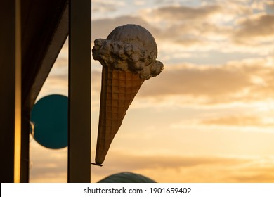 A Large Plastic Ice Cream Waffle In Front Of The Shop Window