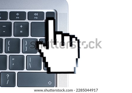Large plastic pixelated hand cursor model touches a modern laptop's fingerprint scanner. Digital security, identity verification and authentication related concept.