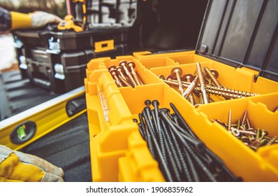 Large Plastic Tool Box Full Of Wood Screws. Construction Zone Job. Other Boxes And Tools In A Background. Industrial Theme.