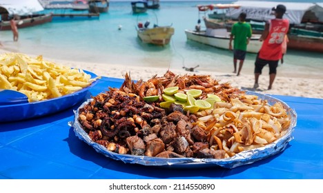 Large Plate With A Mix Of Grilled Seafood Shrimp, Octopus, Tuna Fish, Squid. BBQ Exotic Food On The Beach. Selective Focus.