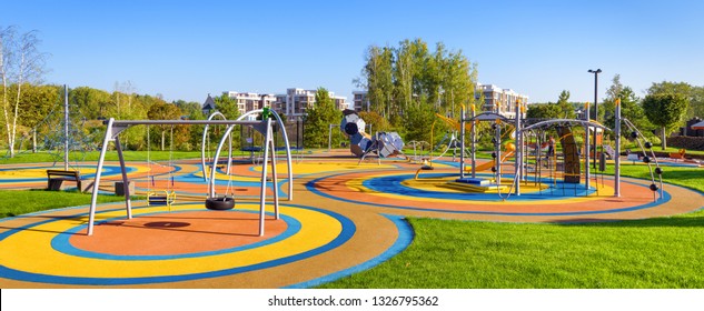 Large playground in city park, empty modern kids playground in summer. Panorama of urban area for children's games and sport. Scenic panoramic view of playing place in town. Scenery of gym outdoor. - Shutterstock ID 1326795362