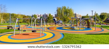 Large playground in city park, empty modern kids playground in summer. Panorama of urban area for children's games and sport. Scenic panoramic view of playing place in town. Scenery of gym outdoor.