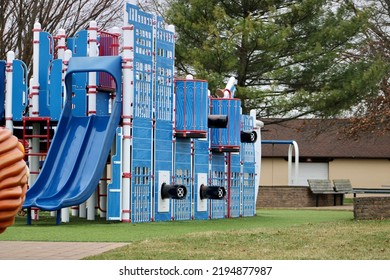 A Large Playground With A Pirate Theme. There Are Sails, A Pirates Only Sign, And Toy Cannons.