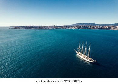 Large Pleasure Boat Off The Coast Of Cascais, Portugal On A Sunny Summer Day. Sintra Mountains In The Background