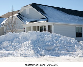 A Large Plowed Pile Of Snow In Front Of A House On The Corner After The 2011 Blizzard In The Midwest