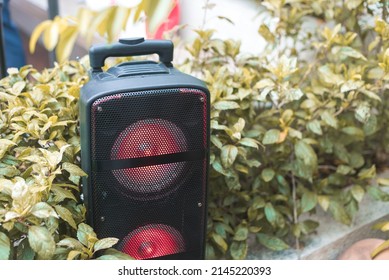 A Large Portable Bluetooth Speaker Placed At A Garden. For An Event Or Picnic Party.gadget, Device, Technology, Volume, Audio