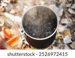 A large pot filled with boiling water is resting on the stove, steadily heating up in preparation for cooking various meals, a very common sight found in many kitchens across the world