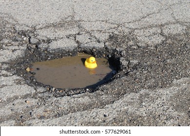 Large Pot Hole In The Road With Rubber Ducky