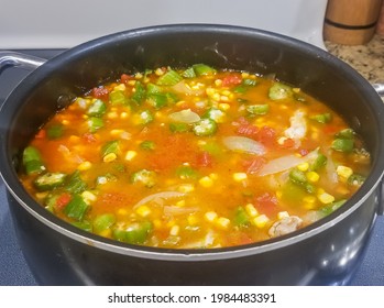 Large Pot Of Vegetable Or Gumbo Soup With Okra, Corn, Tomatoes, And Onions.