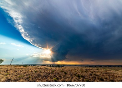 Large, powerful tornadic supercell storm moving over the Great Plains during sunset, setting the stage for the formation of tornados across Tornado Alley. 