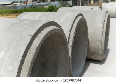 Large Precast Concrete Pipe Segments Prepared On A Road For Sewage, Storm Drain Or Water Supply Project.