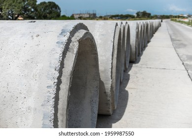 Large Precast Concrete Pipe Segments Prepared On A Road For Sewage, Storm Drain Or Water Supply Project.