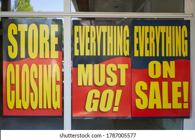 Large Printed Signs At A Closing Retail Store. Liquidation Sale Posters At The Storefront.