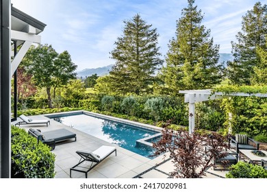 Large private pool surrounded by lush gardens