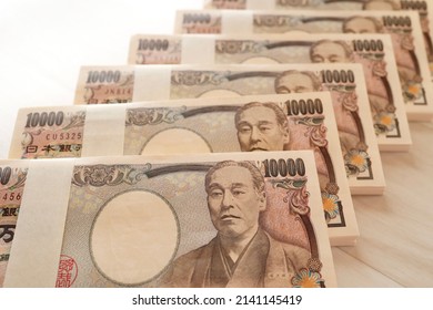 A large quantity of Japanese 10,000 yen bills. Multiple wads of bills. - Shutterstock ID 2141145419