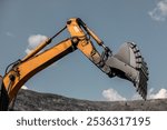 Large quarry dump excavator. Big yellow mining excavator at work site. Loading coal into body truck. Mining digger, mining machinery to loading rock. Production useful minerals. Digger loading coal