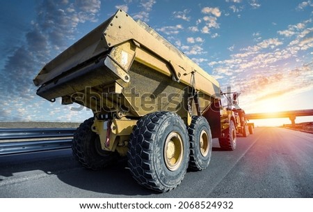 Large quarry dump truck. Big mining truck at work site. Loading coal into body truck.