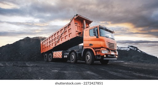 Large quarry dump truck. Dump truck carrying coal, sand and rock. Trucks moving on dirt country road in forest. Mining truck mining machinery to transport coal from open-pit. Transportation of mineral - Shutterstock ID 2272427851