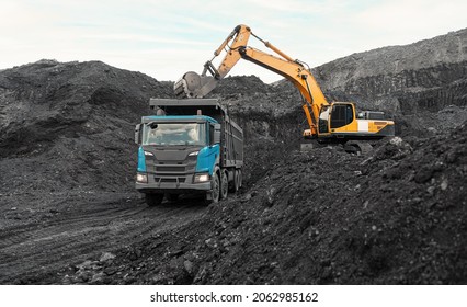 Large quarry dump truck. Loading the rock in dumper. Loading coal into body truck. Production useful minerals. Mining truck mining machinery, to transport coal from open-pit as the Coal Production