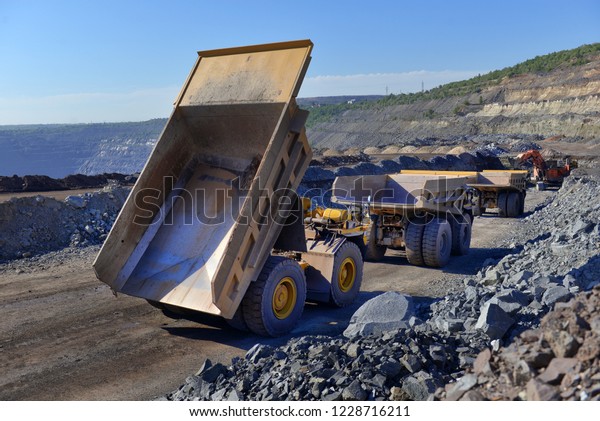 Large quarry dump truck. Loading the\
rock in the dumper. Loading coal into body work truck. Mining truck\
mining machinery, to transport coal from\
open-pit