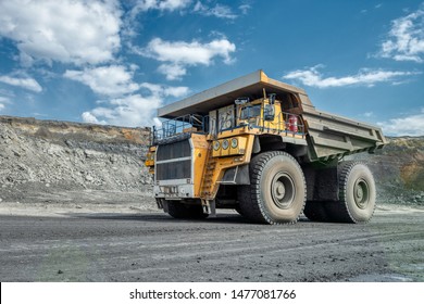 Large Quarry Dump Truck. Transport Industry. A Mining Truck Is Driving Along A Mountain Road. Quarry Truck Carries Coal Mined.