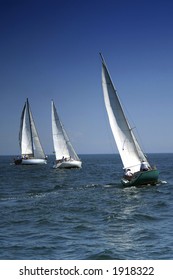 The Large Race Began! Start Of A Sailing Regatta. The Sailing Yachts Compete In Speed.