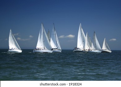 The Large Race Began! Start Of A Sailing Regatta. The Sailing Yachts Compete In Speed.