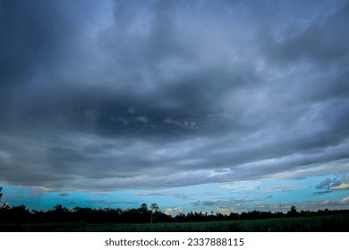 A large rain cloud is forming and falling.