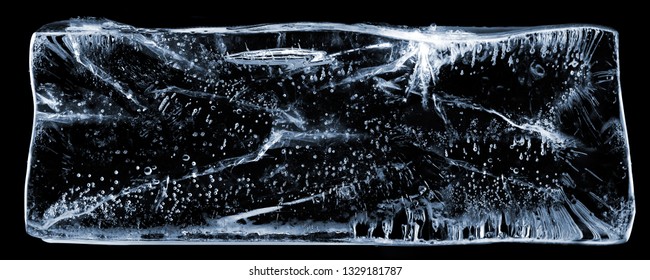 Large rectangle of clear ice with bubbles, on black. Creative concept photo of large rectangle of clear pure cool cold frozen water ice with bubbles on black background. - Shutterstock ID 1329181787