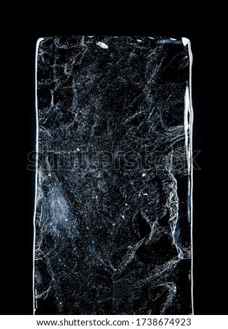 Large rectangle of clear ice with bubbles, against dark background. Block of clear pure frozen ice with air bubbles, isolated on black background with clipping path.
