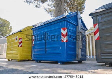 Large recycling containers for waste sorting in urban area.