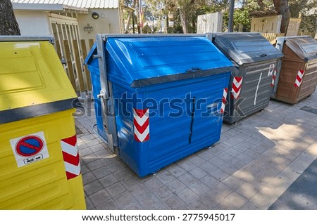 Large recycling containers for waste sorting in urban area.