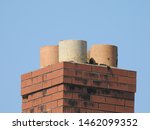 A large red brick chimey with blue sky