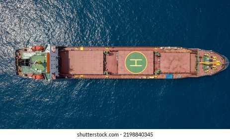 Large Red Cargo Ship At Sea With A Helipad