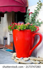 
Large Red Cup Decoration With Flowers Outside In The Corner Of The Restaurant