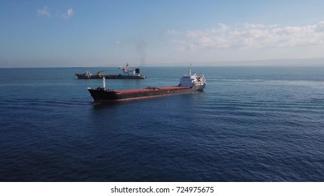 Large RED deck bulk carrier ship sailing in open ocean