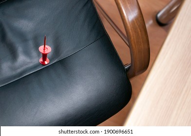 Large red push pin chair  workplace  April Fools' Day  April 1  trusting no one  joke  betrayal  substitute