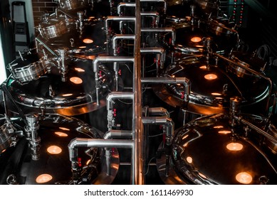 Large Reservoirs, Tanks And Pipes With Manometers In Private Microbrewery. Craft Beer Production Line. Industrial Interior Background.  View From Above.