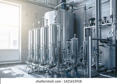 Large reservoirs and tanks and pipes in modern juice and water production plant. Industrial background. - Powered by Shutterstock