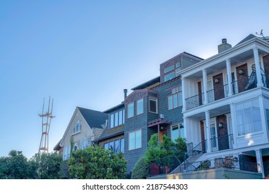 Large Residential Buildings With A View Of The Sutro Tower In San Francisco, California. There Is A Georgian Style Home With Stairs Beside The Gray House Near The House With Gable Roof On The Left.