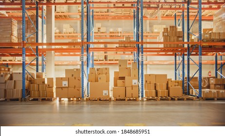 Large Retail Warehouse Full Of Shelves With Goods In Cardboard Boxes And Packages Without People. Logistics, Sorting And Distribution Facility For Product Delivery.