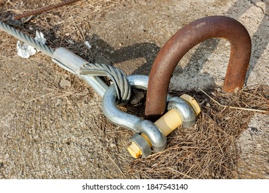 Large Rigging Bracket, Lobe, Shackle. Fastening Of A Twisted Metal Cable To The Installation Embedded Loop In The Concrete Slab.