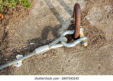 Large Rigging Bracket, Lobe, Shackle. Fastening Of A Twisted Metal Cable To The Installation Embedded Loop In The Concrete Slab.