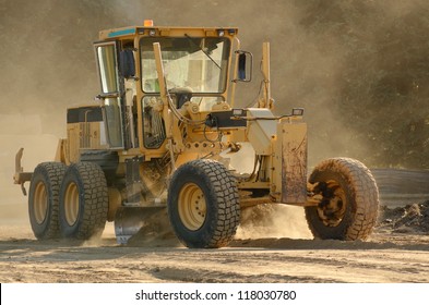 Large road grader working ground at a new commercial housing development