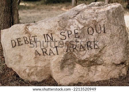 Large rock with the Latin phrase 