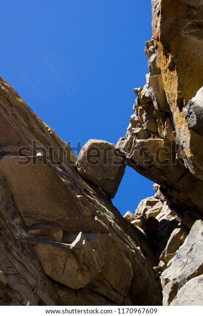 Large rock stuck between\
to rock walls